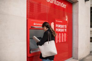 Woman using a Banco Santander ATM
