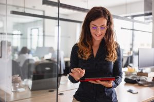 Businesswoman With Glasses Using Digital Tablet In The Office
