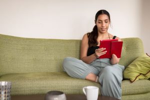 Young black woman with a limb difference using a digital tablet