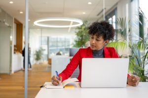 Hispanic businesswoman working at her desk in an office