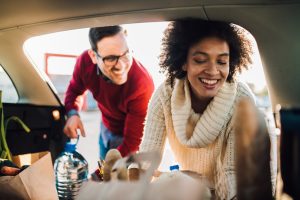Woman putting groceries in a car